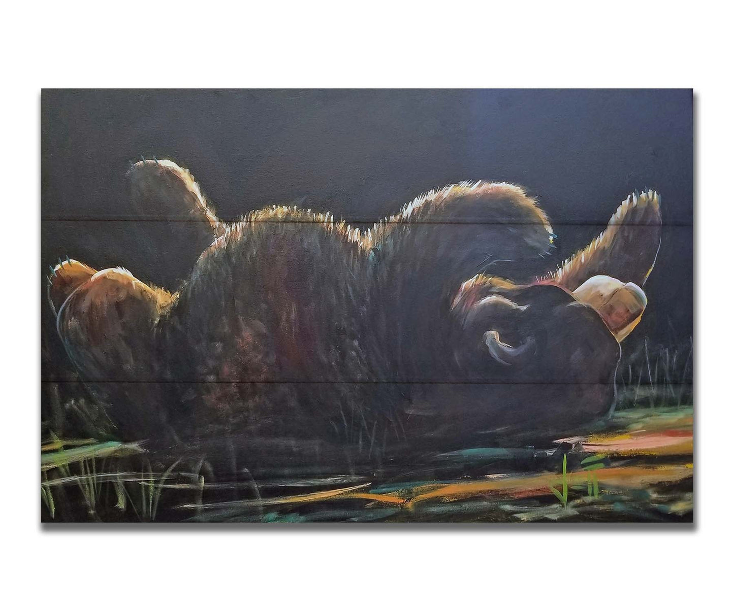 A painting of a bear rolling onto its back, with a dark background. Printed on a box board.