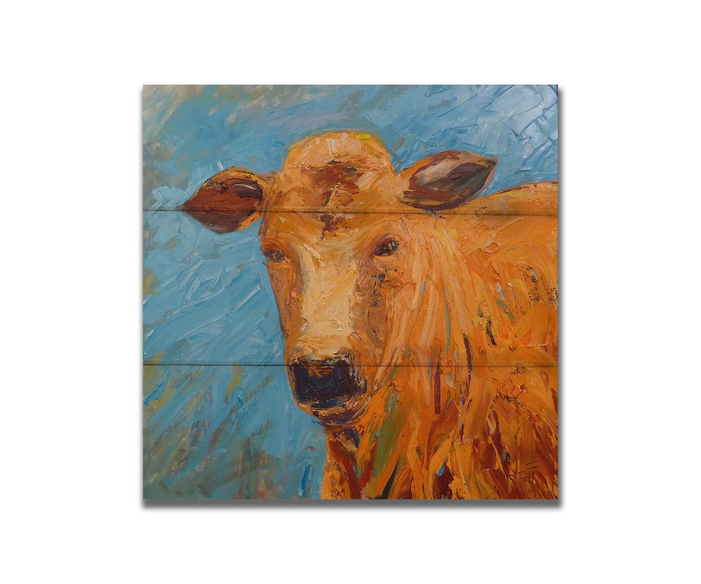 An expressive painting of an orange-brown cow's face against a blue background. Printed on a box board.