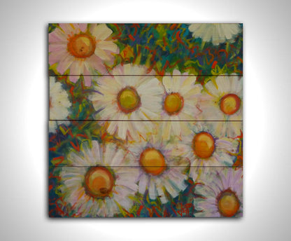 A painting of an arrangement of daisies from above, with an abstracted colorful background in blues, red, and greens. Printed on a wood pallet.