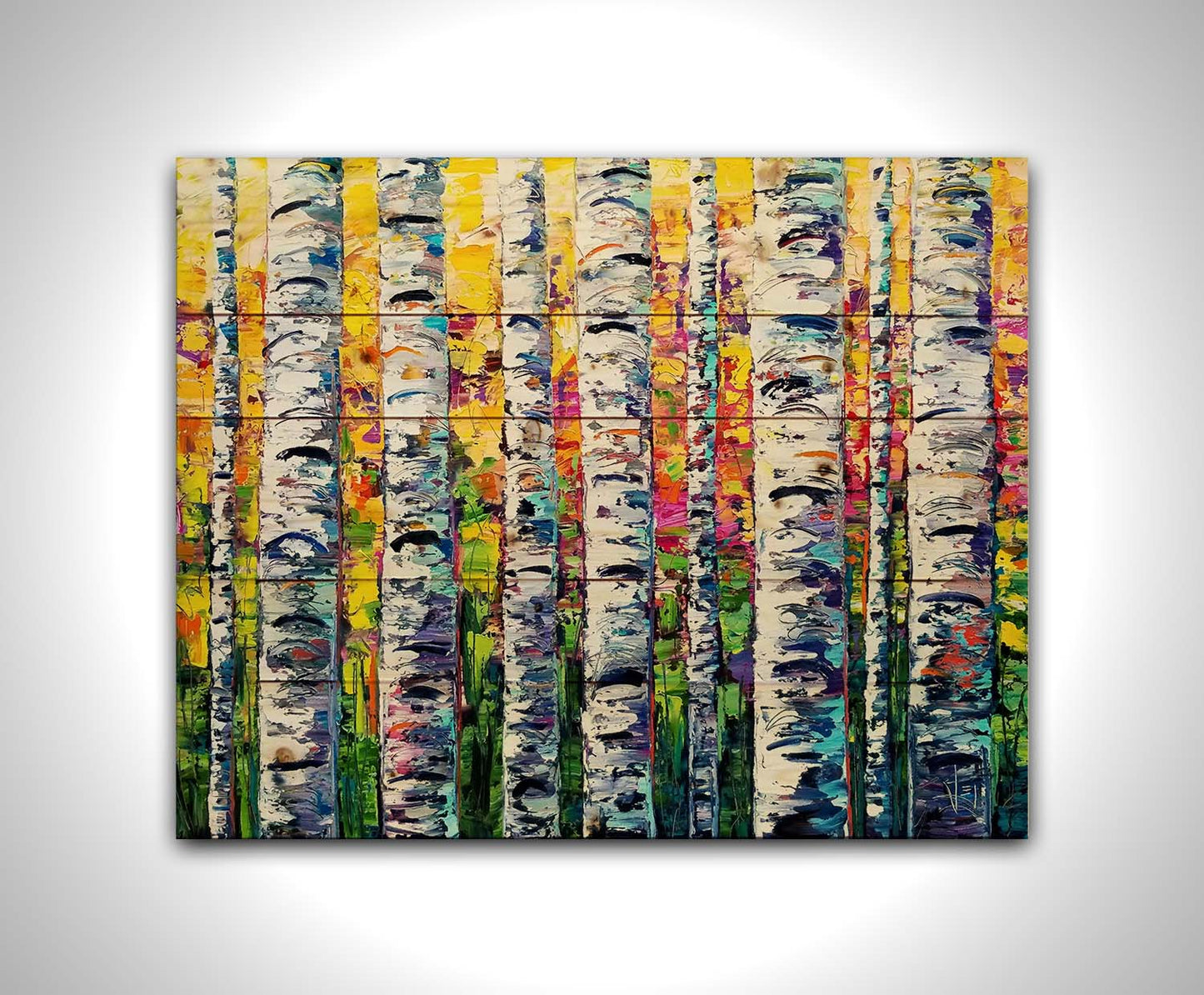 A vibrant painting of white birch trunks, with a background of yellow, pink, and green leaves. Printed on a wood pallet.