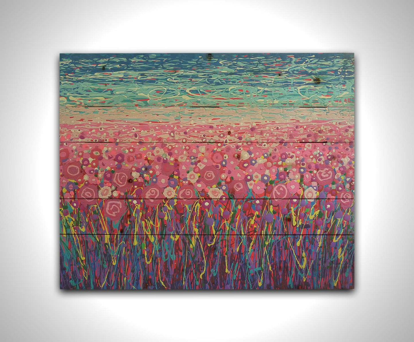 A drip painting of a field of pink and purple flowers, accented with red, yellow, green, and white. Printed on a wood pallet.