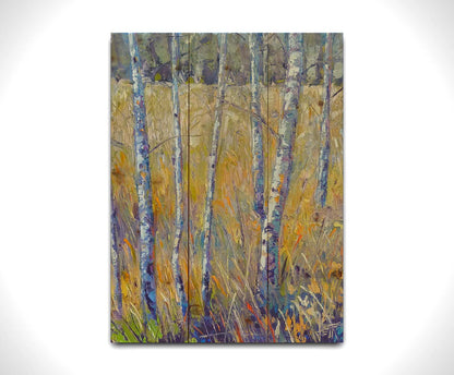 A painting of birch trunks growing surrounded by yellow grasses of fall. Printed on a wood pallet.