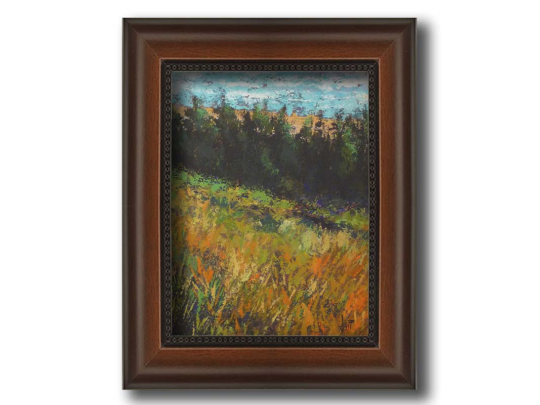 A painting of a grassy green and orange hill, lined in the distance by evergreen trees. Printed on canvas and framed.