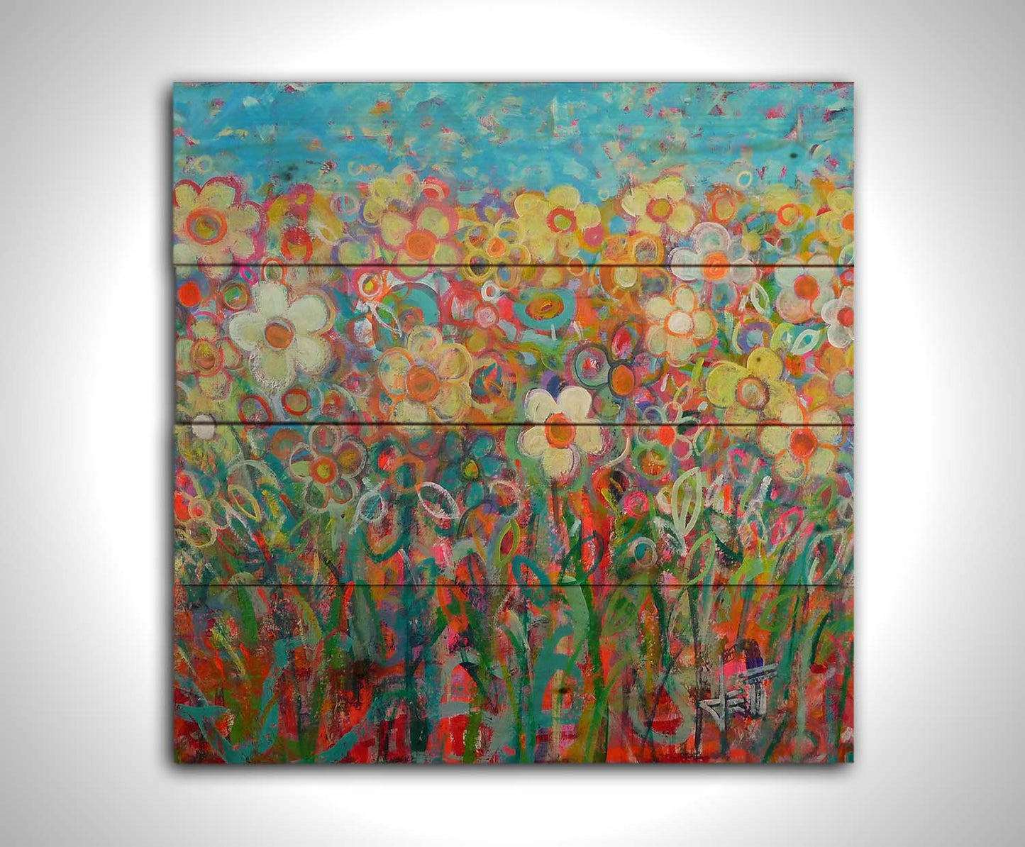 A painting of a simplified field of flowers in a variety of colors, set against a bright blue sky. Printed on a wood pallet.