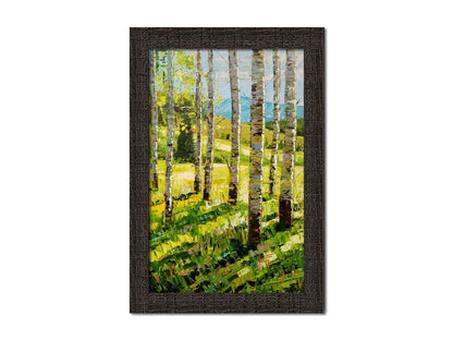 A painting of a group of birch tree trunks before a bright green grassy hill. Printed on canvas and framed.