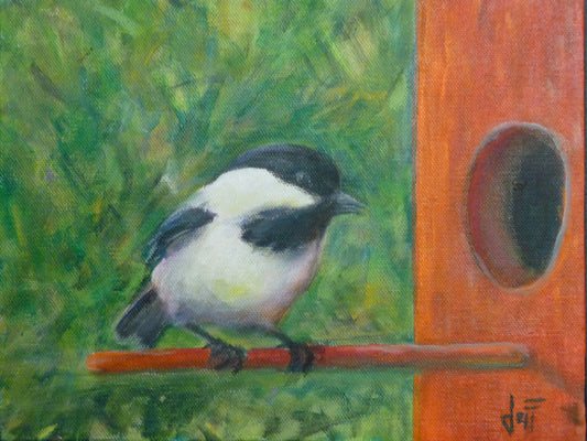 A painting of a black and white chickadee perched on an orange birdhouse, about to enter. The visible brushstrokes of the green background give the impression of foliage.
