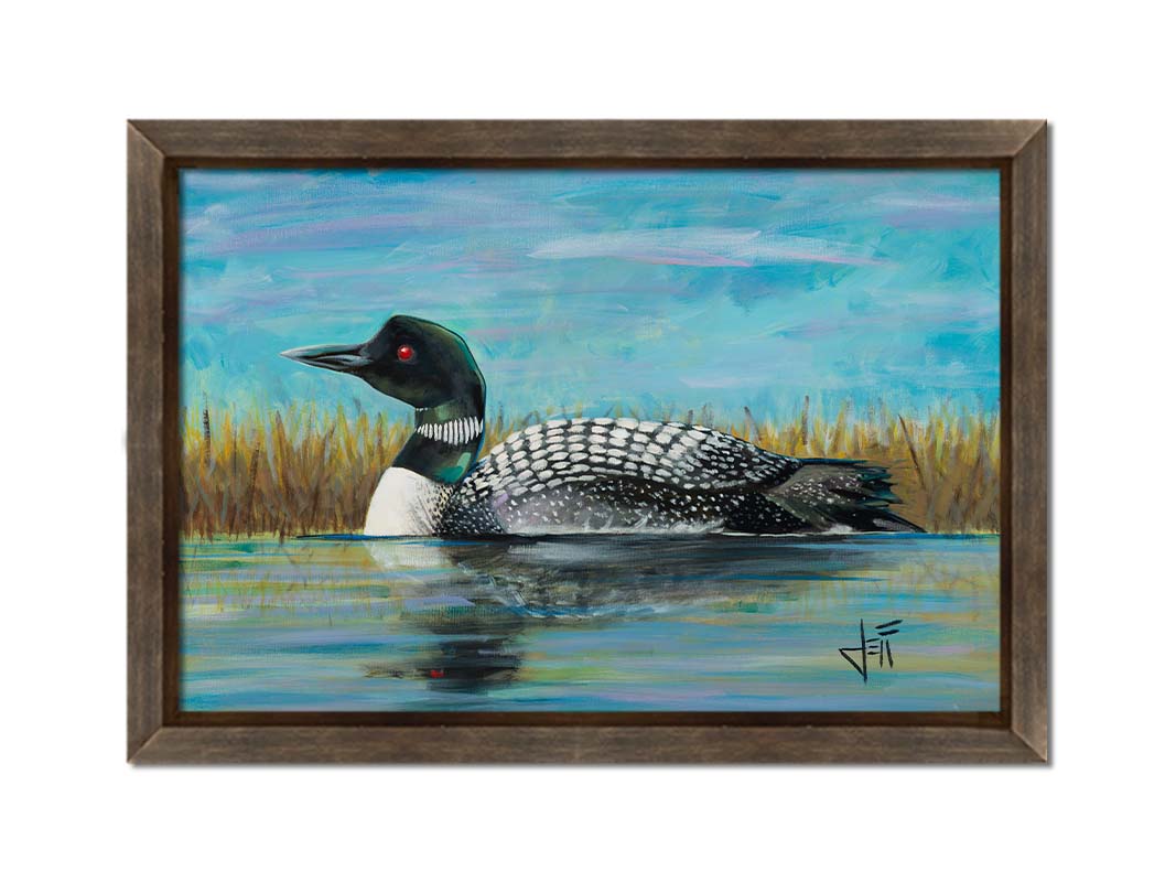 A painting of a loon swimming on the water, reflected on the surface. Printed on canvas and framed.