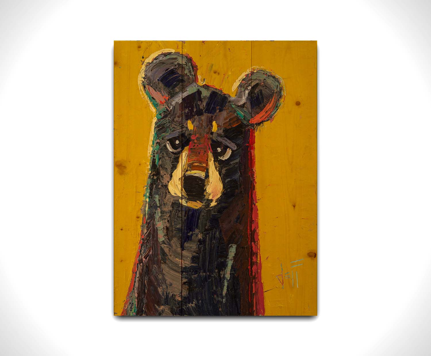 A portrait painting of a brown bear, accented with green and red, against a bright yellow background. Printed on a wood pallet.