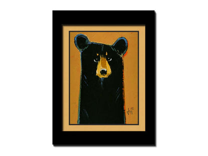 A painting of a black bear set against a yellow-orange background. It is simplified in a contemporary style that emphasizes the shape of the bear. Printed on paper, matted, and framed.