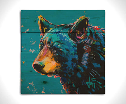 A painting of a black bear against a blue background. Printed on a wood pallet.