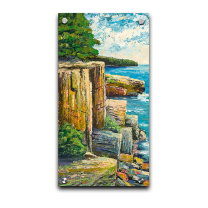 A painting overlooking a waterside clifface. Green forests grow across the tops of the cliffs, and the bright blue waters below splash against a colorful collection of rocks. Printed on acrylic.