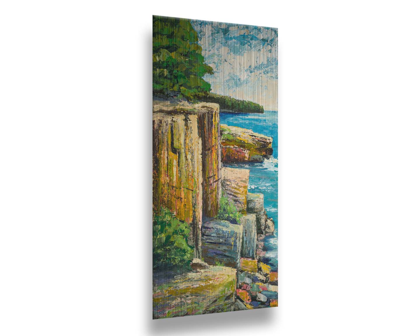 A painting overlooking a waterside clifface. Green forests grow across the tops of the cliffs, and the bright blue waters below splash against a colorful collection of rocks. Printed on metal.