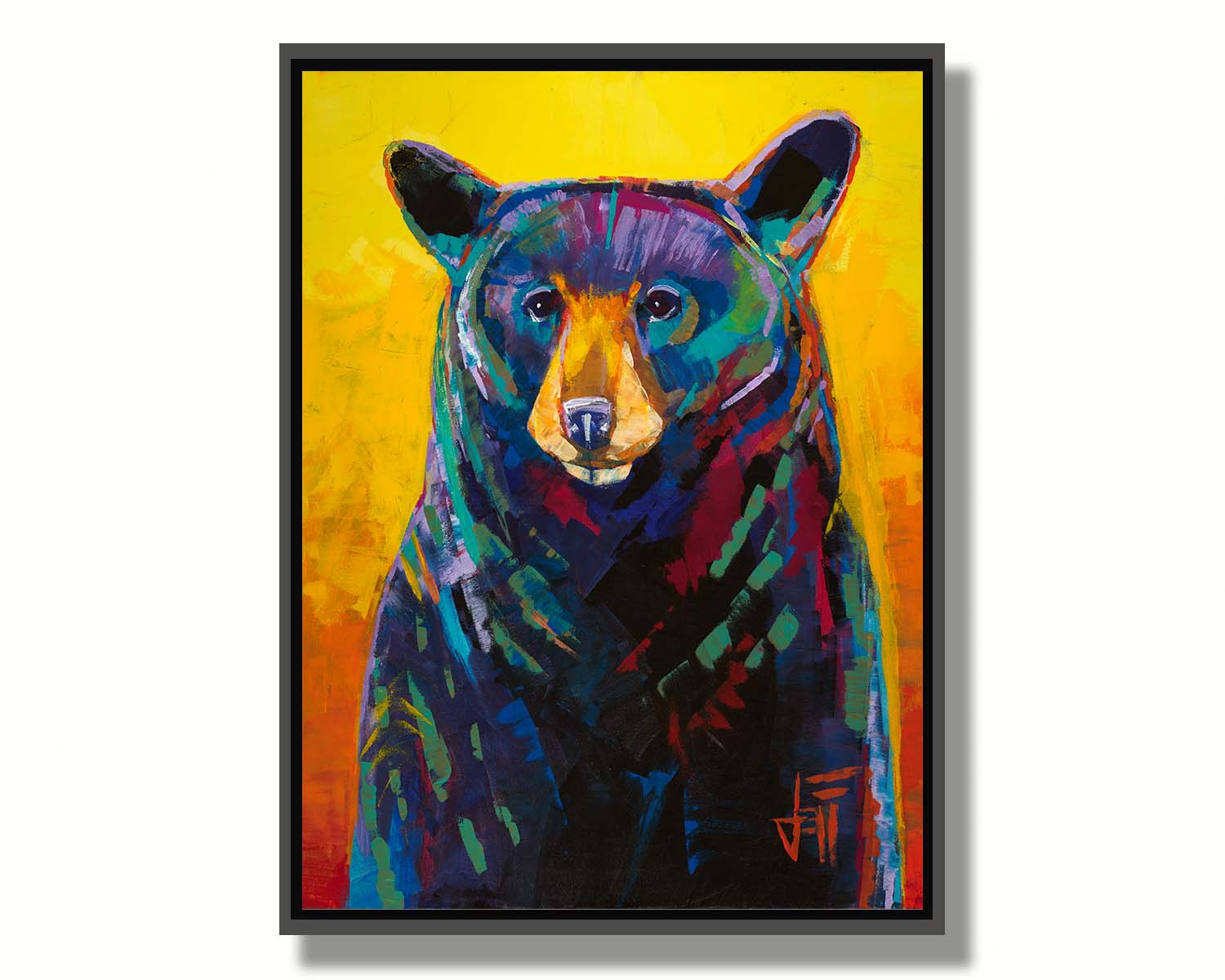 A portrait painting of a black bear, represented in colorful accents of reds, blues, greens, and purples against an orange and yellow background. Printed on canvas in a float frame.