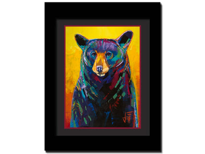 A portrait painting of a black bear, represented in colorful accents of reds, blues, greens, and purples against an orange and yellow background. Printed on paper, matted, and framed.