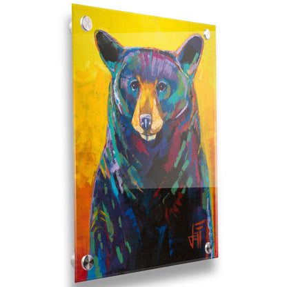 A portrait painting of a black bear, represented in colorful accents of reds, blues, greens, and purples against an orange and yellow background. Printed on acrylic.