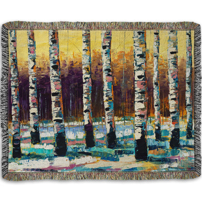 A woven throw blanket designed with a colorful, textured painting of a birch forest on a snowy winter day.