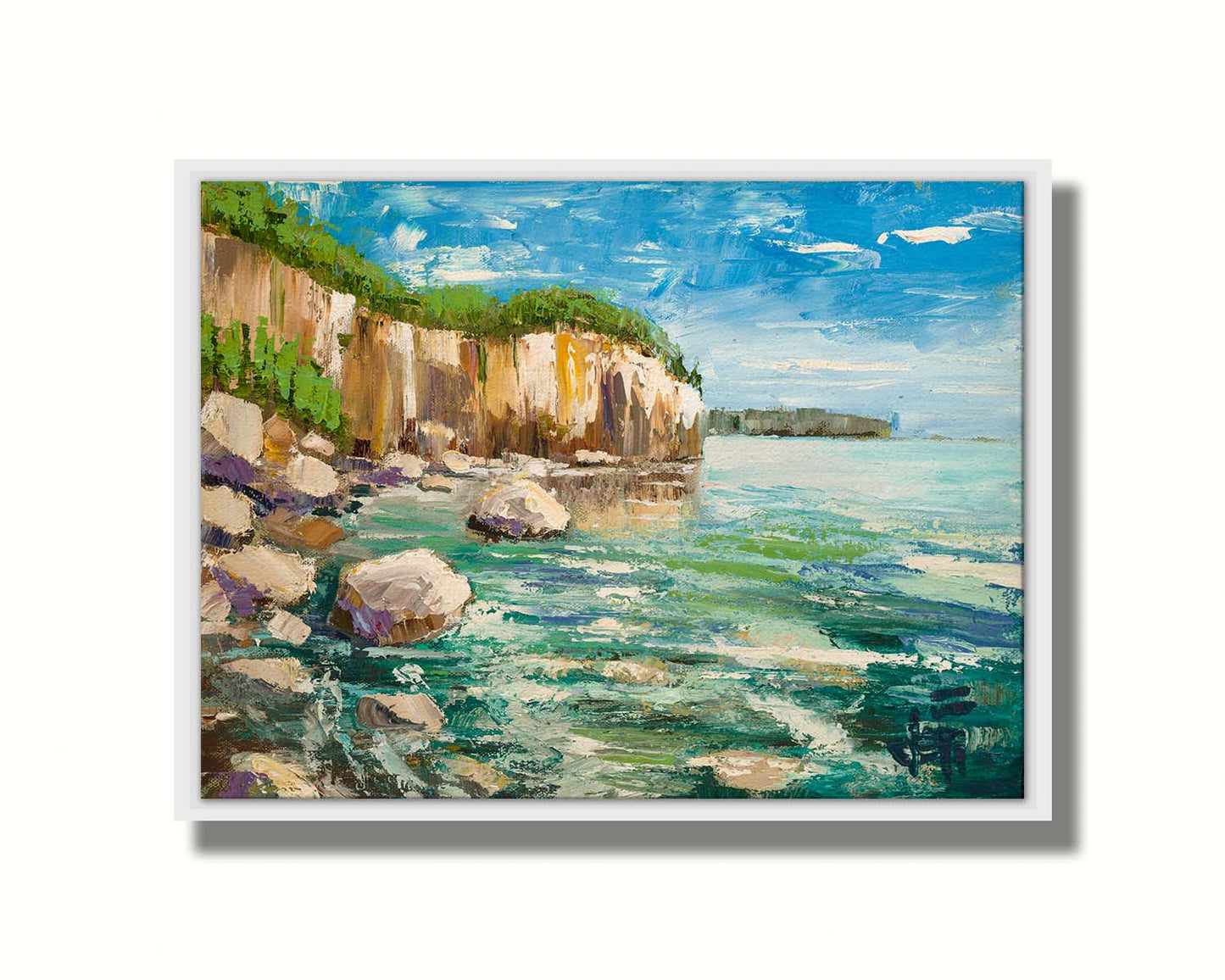 A painting of a rocky cliff overlooking clear waters on a sunny day. A vibrant green forest is growing on top of the cliffs. The teal water splashes against rocks on the shore. Printed on canvas in a float frame.