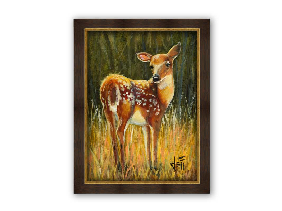 A painting of a baby deer, standing in a grassy field. before a green forest. Printed on canvas and framed.