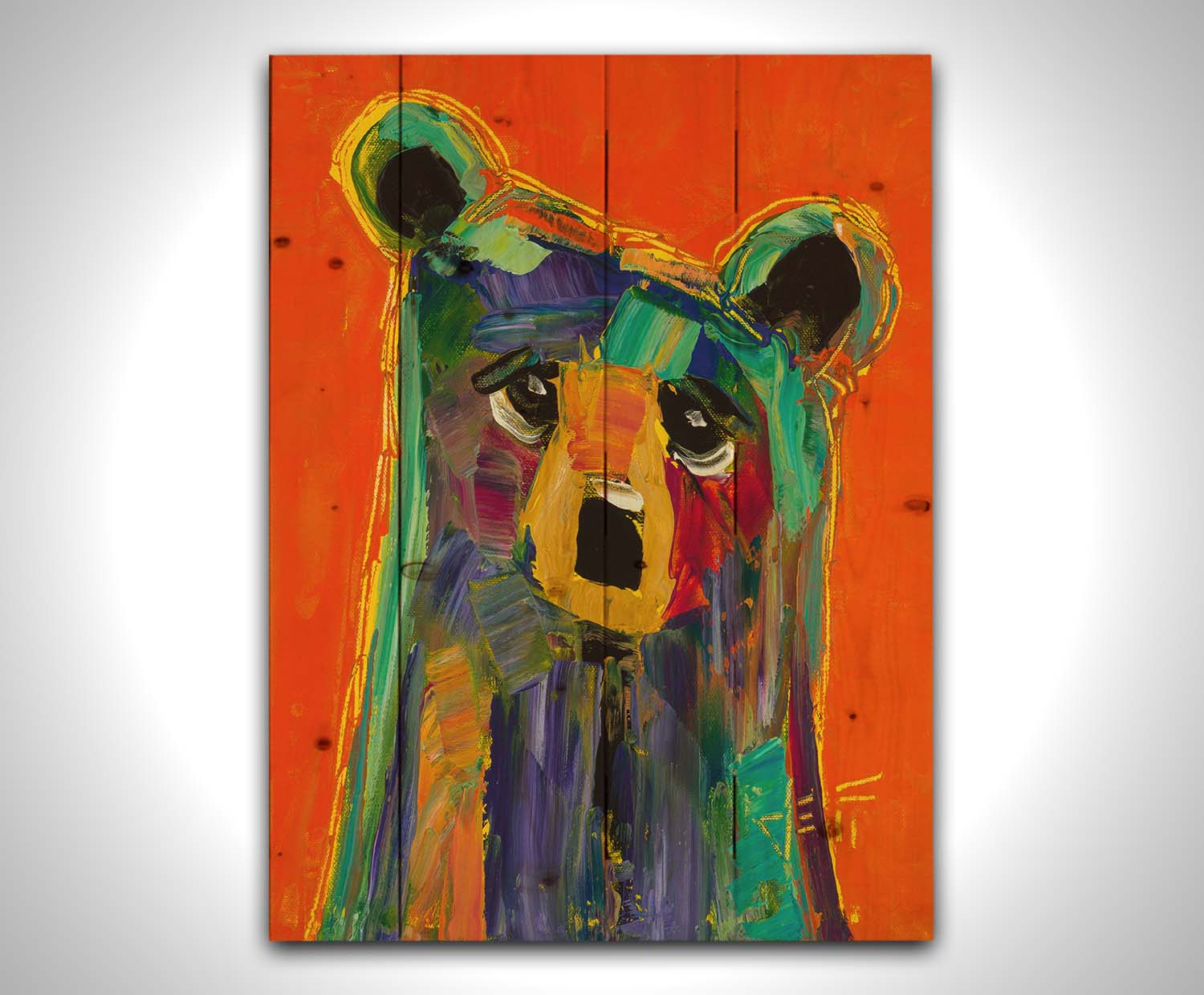 A contemporary portrait painting of a bear, in a style focusing on color and shape. Large brushstrokes of unblended blue, teal, pink, yellow, and orange create a simplified cartoonish bear. Printed on a wood pallet.