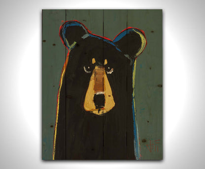 A portrait of a black bear in a simple style utilizing flat planes of color. It is outlined in red, orange, yellow, green, and blue, and set against a dusty green background. Printed on a wood pallet.