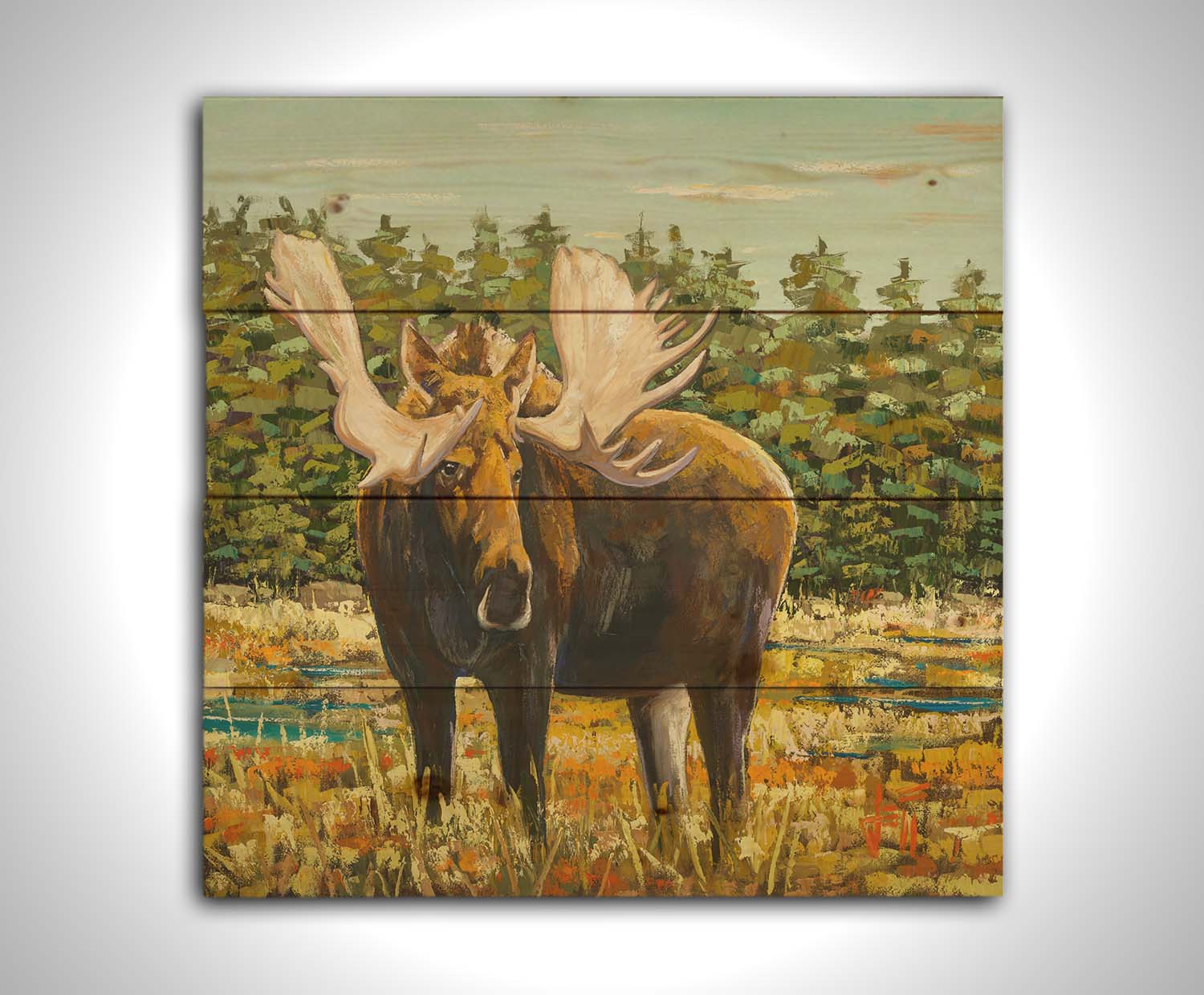 A painting of a moose standing in a bright yellow and orange field, dotted with blue puddles. An evergreen forest borders this Gunflint Trail field in Minnesota. Printed on a wood pallet.