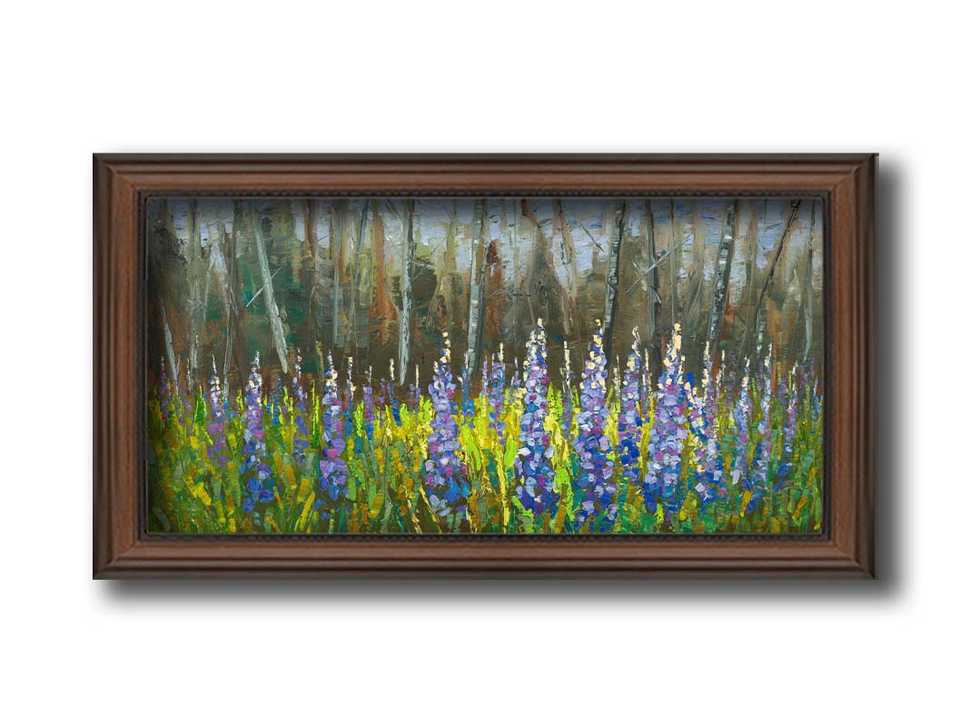 A painting of a field of blue and purple lupine flowers in a green field, backed by a forest. Printed on canvas and framed.