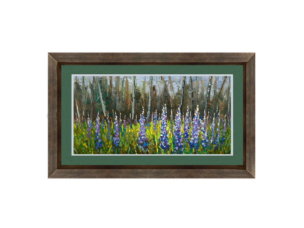 A painting of a field of blue and purple lupine flowers in a green field, backed by a forest. Printed on paper, matted, and framed.