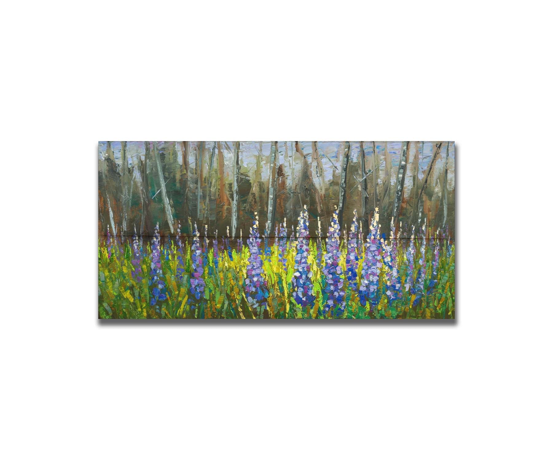 A painting of a field of blue and purple lupine flowers in a green field, backed by a forest. Printed on a box board.