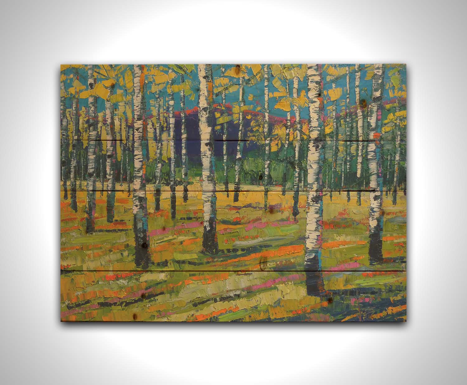 A painting of a birch or aspen forest in front of a blue mountain range. Green and yellow leaves match the ground beneath, accented with oranges and pinks. Thick lines and visible rectangular brushstrokes move the piece. Printed on a wood pallet.