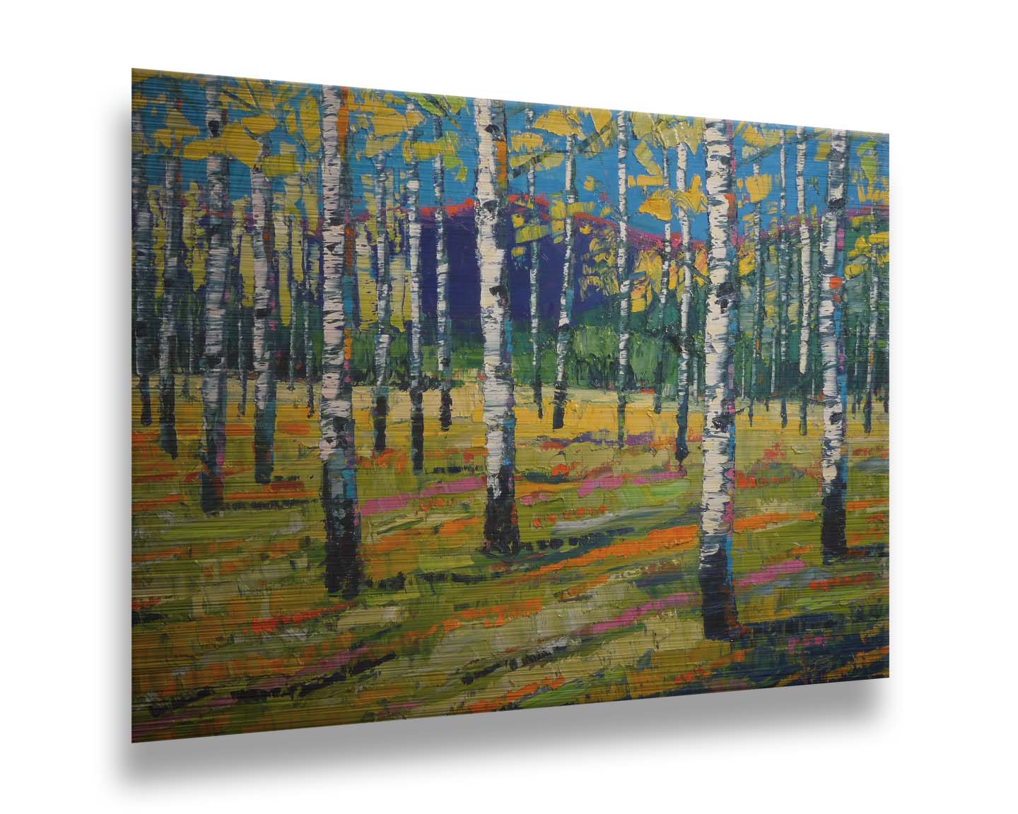 A painting of a birch or aspen forest in front of a blue mountain range. Green and yellow leaves match the ground beneath, accented with oranges and pinks. Thick lines and visible rectangular brushstrokes move the piece. Printed on metal.