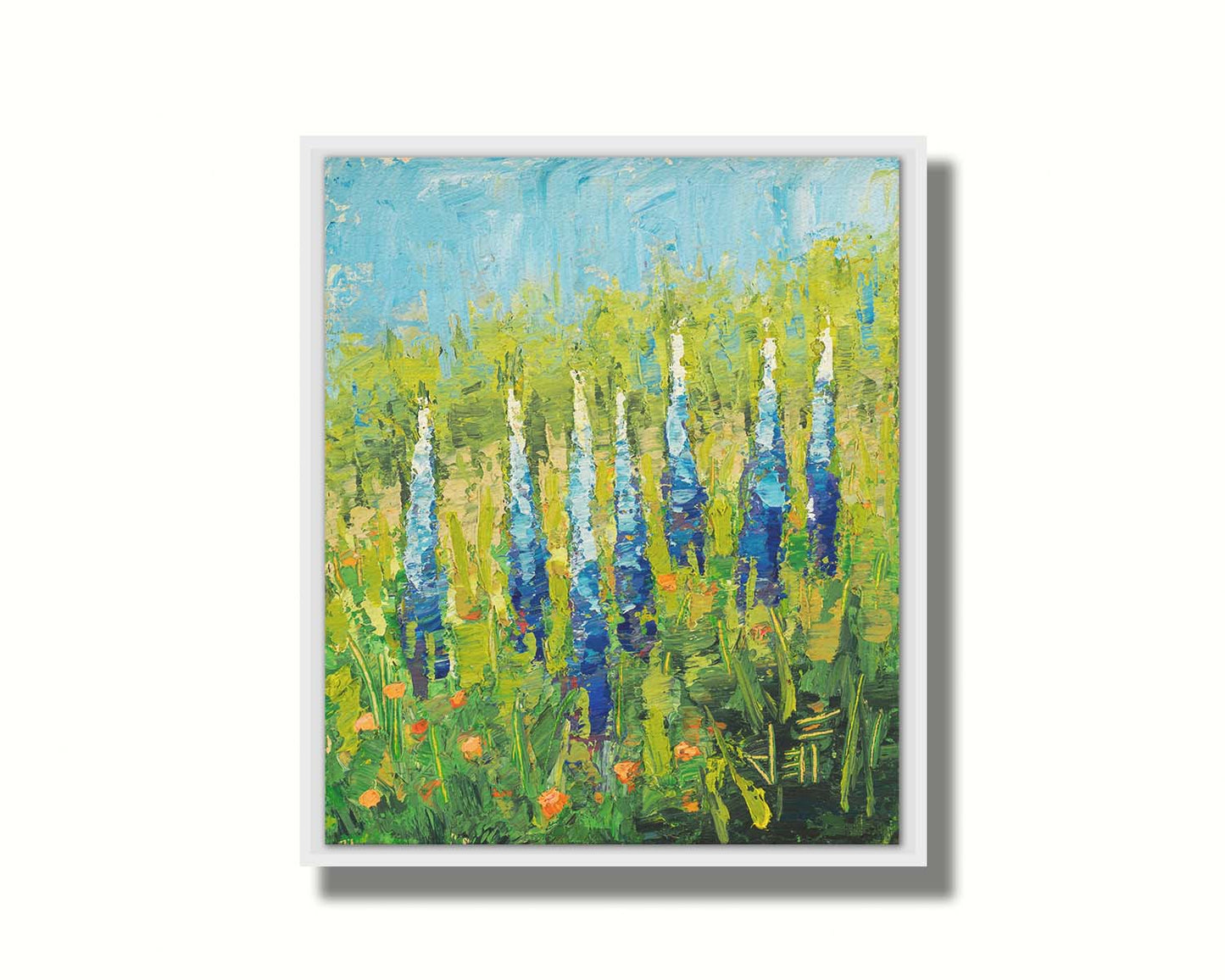 An impasto painting of blue lupine flowers in a green field, complimented by small orange flowers. Printed on canvas in a float frame.