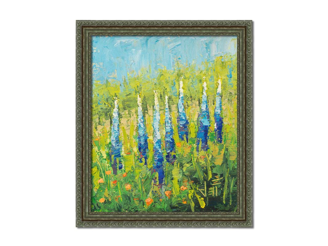 An impasto painting of blue lupine flowers in a green field, complimented by small orange flowers. Printed on canvas and framed.