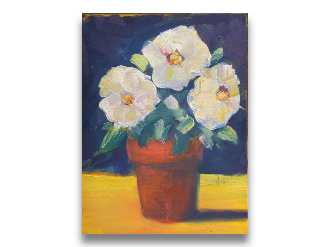 A painting of three white flowers in an orange clay pot. It is sitting on a yellow surface against a dark blue bathroom. Printed on canvas.