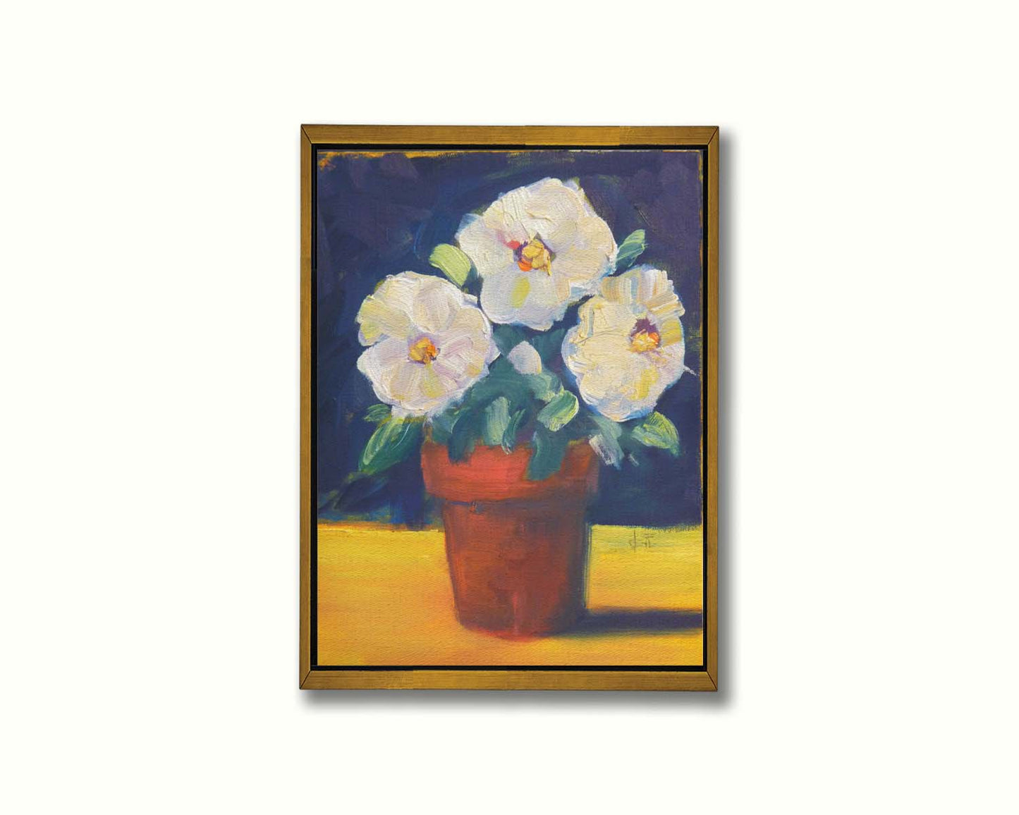 A painting of three white flowers in an orange clay pot. It is sitting on a yellow surface against a dark blue bathroom. Printed on canvas in a float frame.