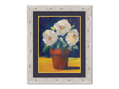 A painting of three white flowers in an orange clay pot. It is sitting on a yellow surface against a dark blue bathroom. Printed on paper, matted, and framed.