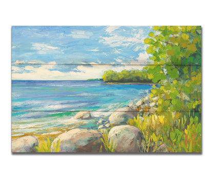 A painting of a calm bayside view. Bright green trees and foliage line the shore alongside smooth gray stones, and a blue sky with fluffy clouds reflects off smooth waters. Printed on a box board.