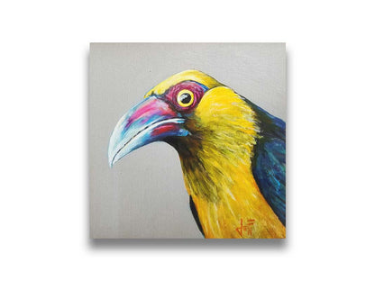 A painting of a striking saffron toucanet, whose yellow feathers pop against the neutral gray background. The light reflecting off its eye gives it an intense, intrigued, lifelike gaze. Printed on canvas.