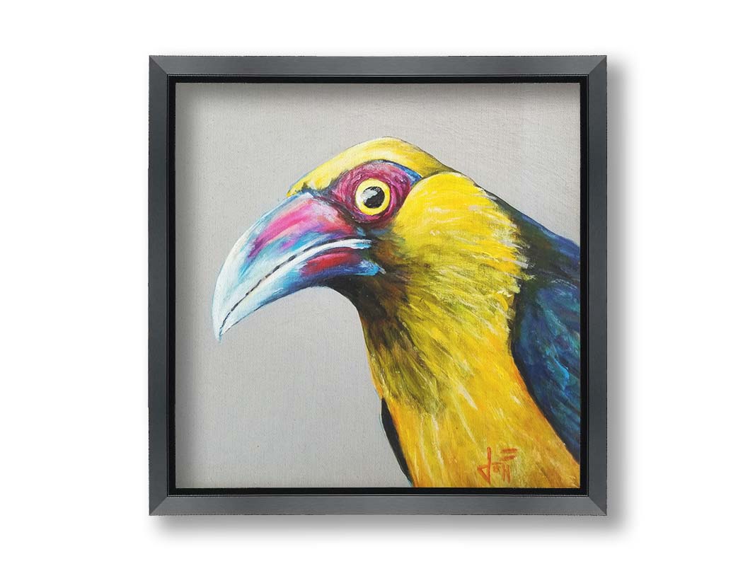 A painting of a striking saffron toucanet, whose yellow feathers pop against the neutral gray background. The light reflecting off its eye gives it an intense, intrigued, lifelike gaze. Printed on canvas and framed.