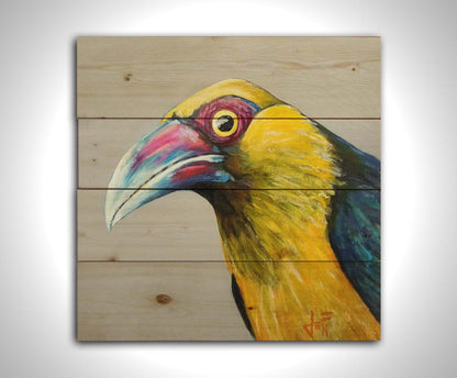 A painting of a striking saffron toucanet, whose yellow feathers pop against the neutral gray background. The light reflecting off its eye gives it an intense, intrigued, lifelike gaze. Printed on a wood pallet.