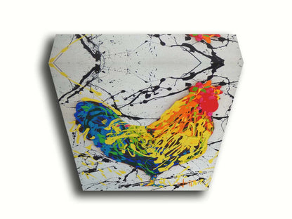 A drip painting of a rooster in red, orange, yellow, green, and blue set against a white background speckled with black and yellow. Printed on canvas.