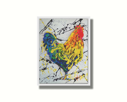 A drip painting of a rooster in red, orange, yellow, green, and blue set against a white background speckled with black and yellow. Printed on canvas in a float frame.