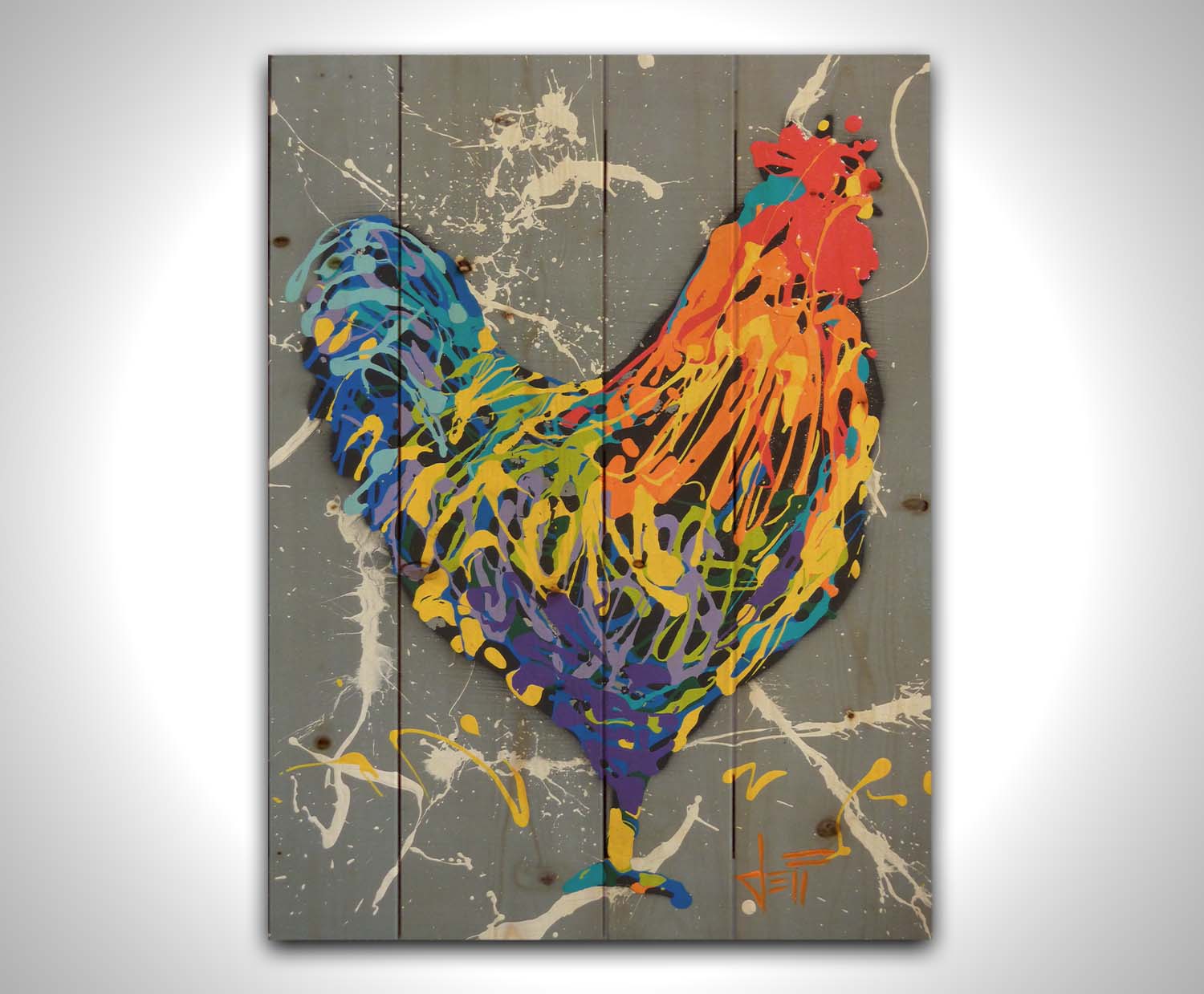 A drip painting of a rooster in a rainbow of colors, against a sleek gray backdrop, accented by white splashes. Printed on a wood pallet.