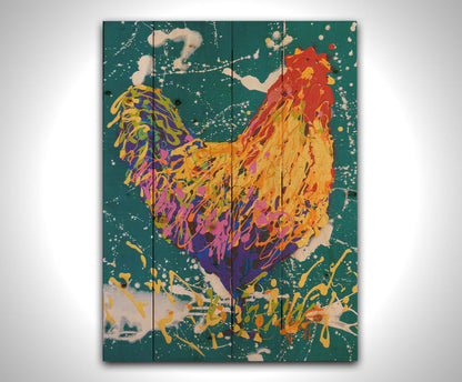 A drip painting of a rooster in vibrant shades of orange, pink, and purple against a rich teal background highlighted by white drips. Printed on a wood pallet.