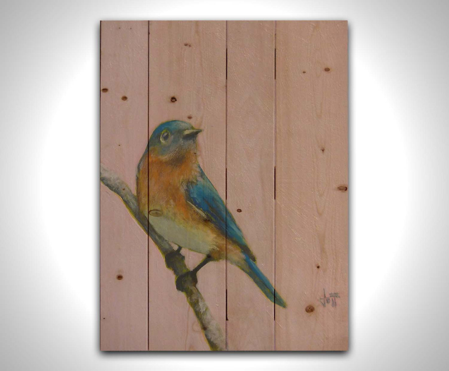 A portrait painting of an eastern bluebird with blue and orange feathers, delicately perched on a twig against a dusty rose pink background. Printed on a wood pallet.