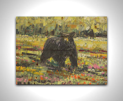 An impasto painting of a black bear wandering through a vibrant field, surrounded by a forest. It is created with an impasto technique using rectangular brushstrokes. Printed on a wood pallet.