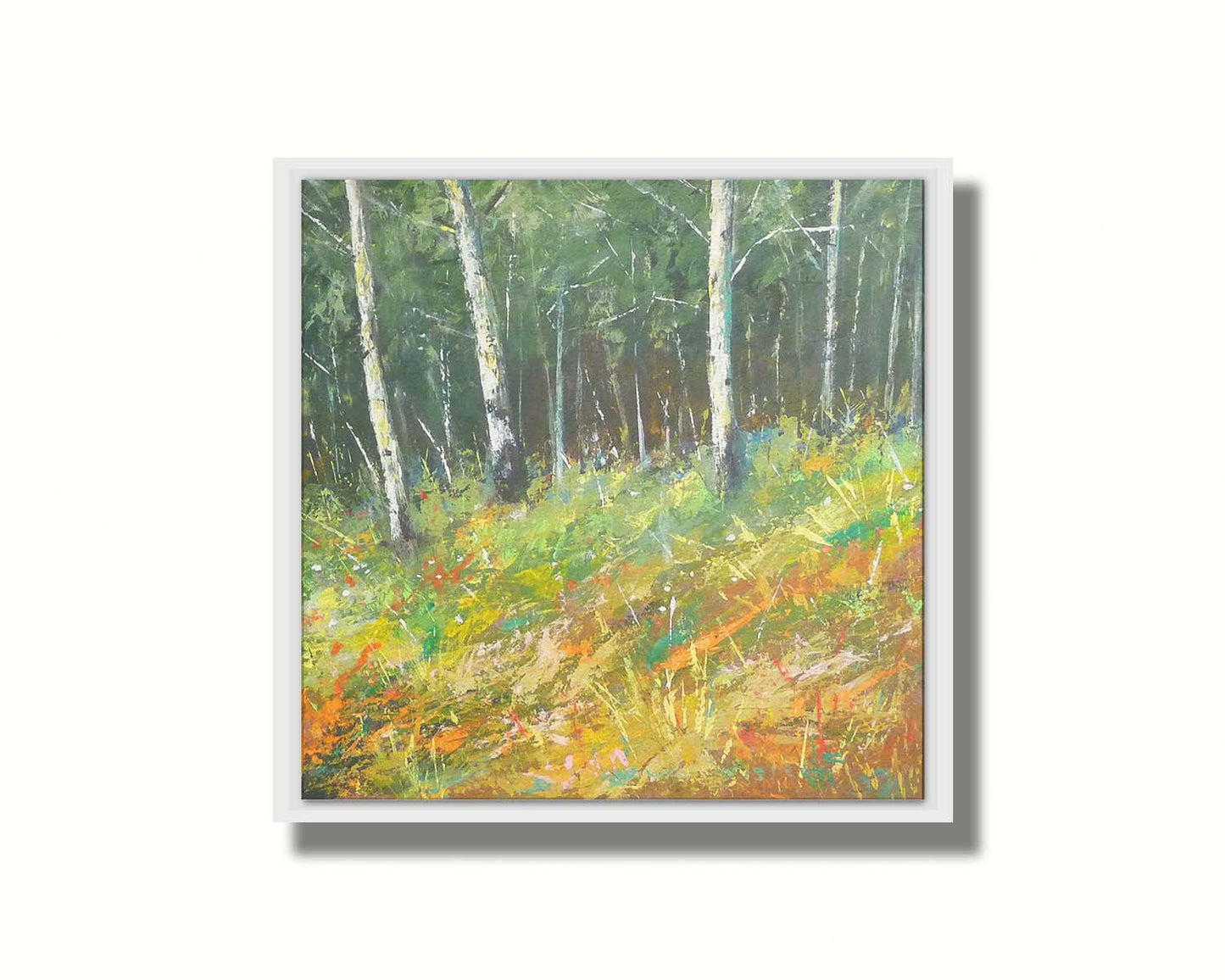 A painting of a hillside forest with colorful grasses in yellows, oranges, and greens. Printed on canvas in a float frame.