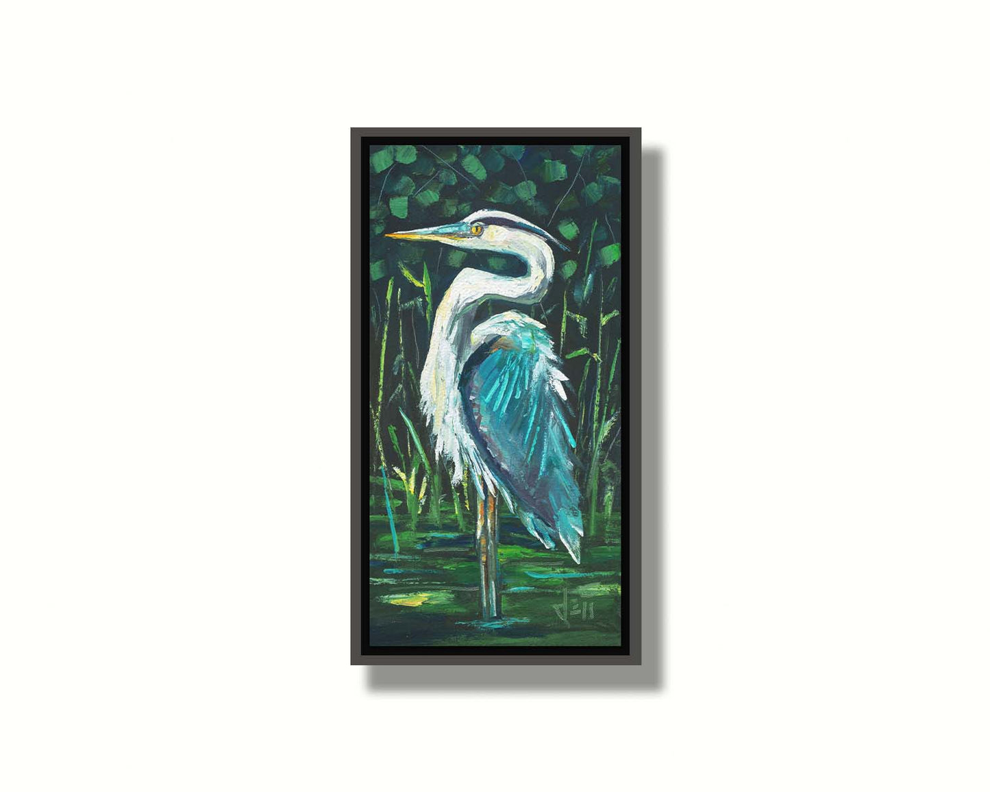 A painting of a great blue heron standing tall in a pond surrounded by vibrant foliage. Printed on canvas in a float frame.