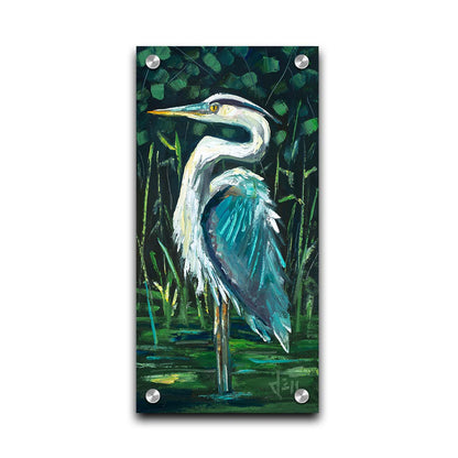 A painting of a great blue heron standing tall in a pond surrounded by vibrant foliage. Printed on acrylic.