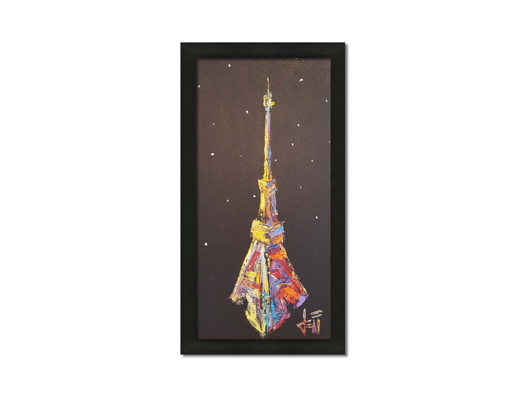 A painting of an abstracted rendition of the iconic Eiffel Tower in bright colors against a black background with white speckles. Printed on canvas and framed.