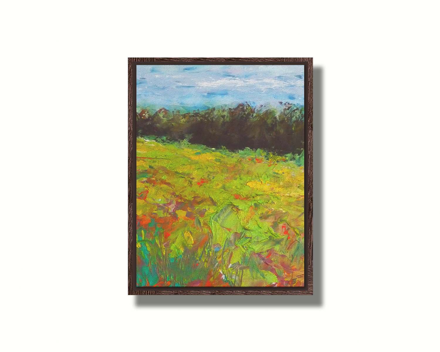 A landscape painting of a colorful meadow bordered by a lush forest, created using vibrant green impasto with pops of orange, pink, yellow, and blue. Printed on canvas in a float frame.
